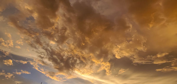 Low angle view of dramatic sky during sunset