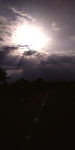 Silhouette of road against sky during sunset