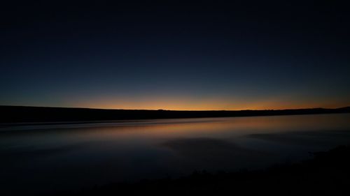 Scenic view of silhouette landscape against sky at sunset