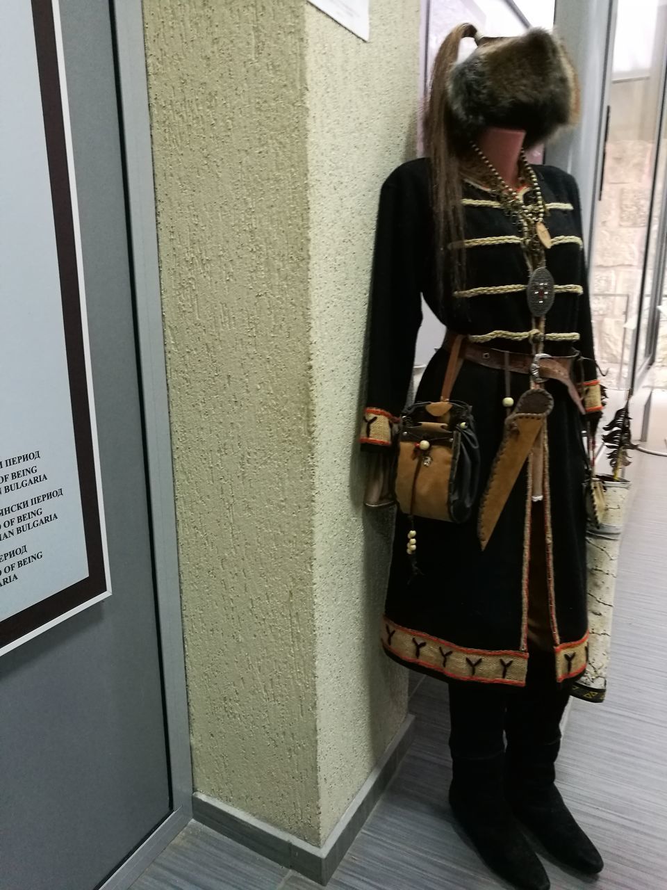 WOMAN STANDING AGAINST WINDOW