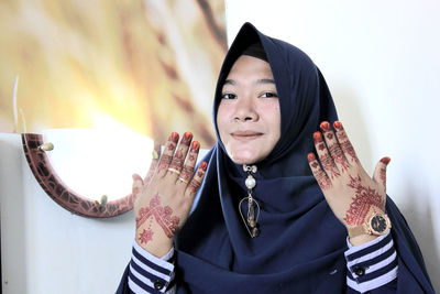 Portrait of young woman showing henna tattoo