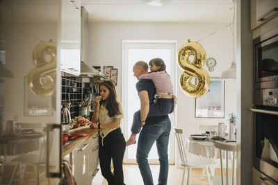 Father and daughters getting ready for birthday party