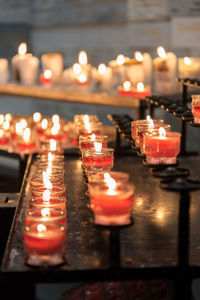 Illuminated tea light candles in temple