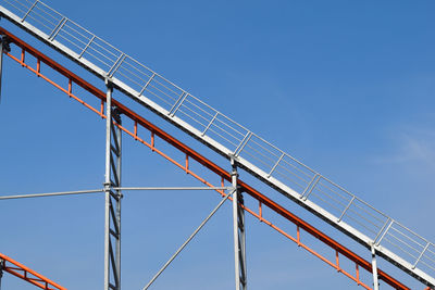 Low angle view of bridge against clear blue sky