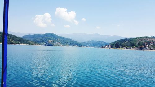 Scenic view of sea and mountains against sky