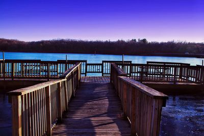 Pier on lake during winter at night