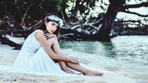 Portrait of woman sitting in water