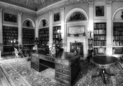 Empty chairs and tables in building