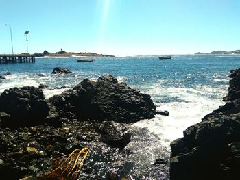 Scenic view of sea against clear blue sky