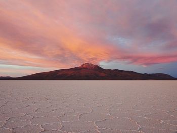 Scenic view of desert against sky during sunset