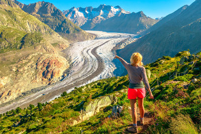 Rear view of woman standing on mountain