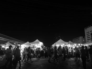 Crowd at illuminated city at night