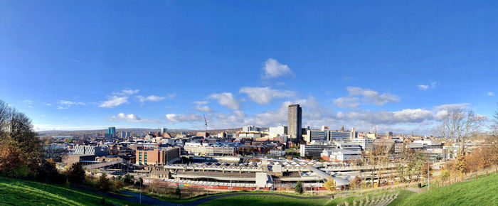 High angle view of sheffield city buildings against blue sky