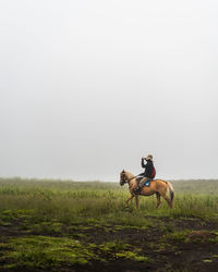 Man riding horse on land