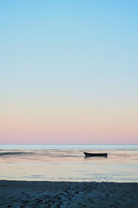 Scenic view of sea against clear sky during sunset