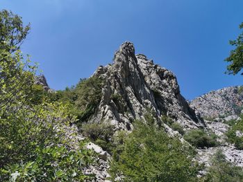 Low angle view of rock formation against sky