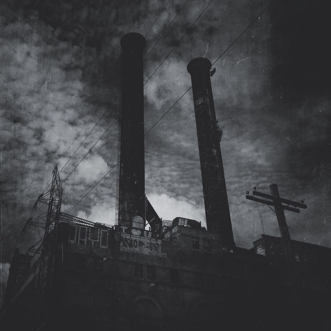 low angle view, built structure, architecture, building exterior, sky, religion, silhouette, cross, old, spirituality, dusk, cloud - sky, outdoors, no people, place of worship, smoke stack, history, abandoned