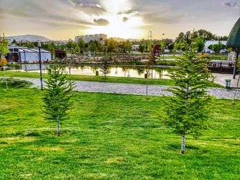 Scenic view of river by buildings against sky