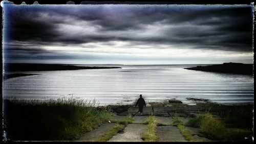 Scenic view of sea against cloudy sky