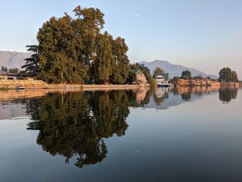 Reflection of trees in lake against sky