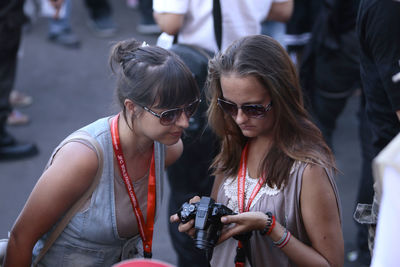 Young woman photographing in city