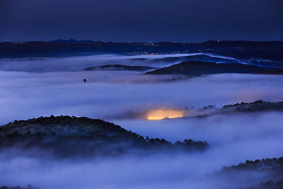 Scenic view of mountains against sky at night