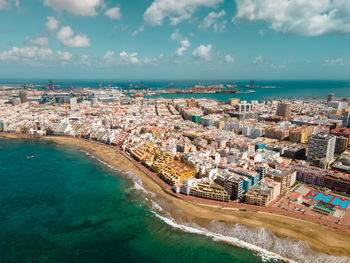 High angle view of buildings by sea against sky