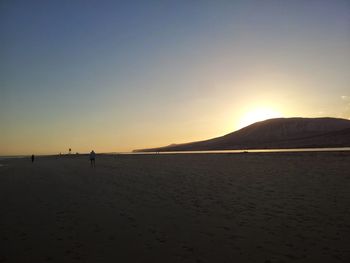 Scenic view of beach against sky during sunset