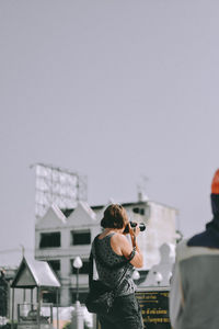 Rear view of man photographing