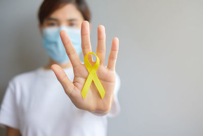 Portrait of woman holding yellow flower