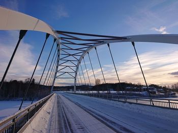 View of suspension bridge against sky during winter