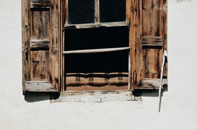 Close-up of open window in building during sunny day
