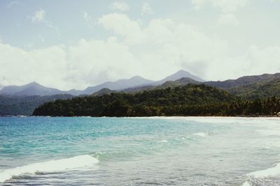 Scenic view of sea and mountains against sky