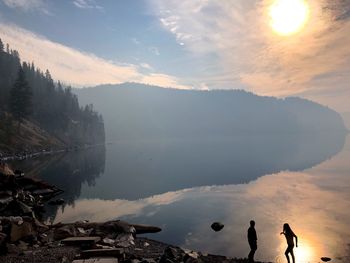 Scenic view of lake against sky during sunset