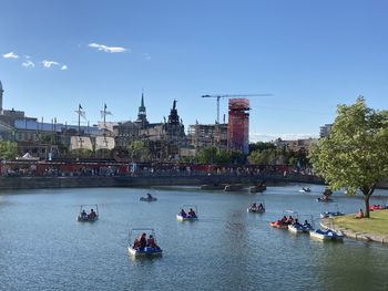 Boats in river with buildings in background