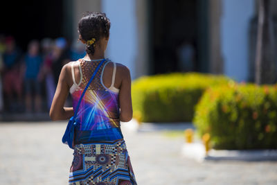 Rear view of woman standing outdoors