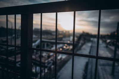 Close-up of glass window against sky during sunset