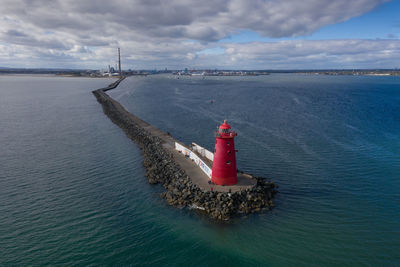 Aerial view of poolberg lighthouse on coastline of dublin at sunny day