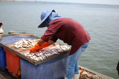 Man holding fish at beach