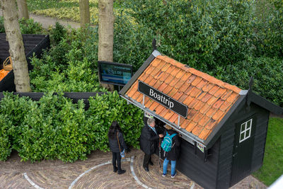 Rear view of people walking on plants