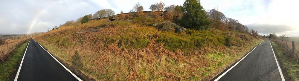 Panoramic view of road amidst land against sky