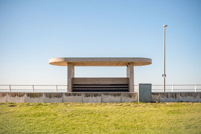 Built structure on field against clear sky