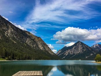 Scenic view of lake against cloudy sky