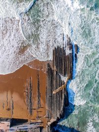 Panoramic view of icicles on rock formation in sea