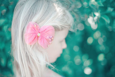 Close-up portrait of woman with pink flower