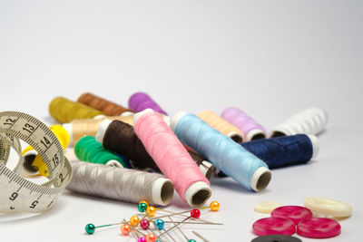 Close-up of multi colored pencils on table against white background