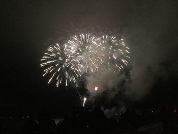 Low angle view of firework display at night