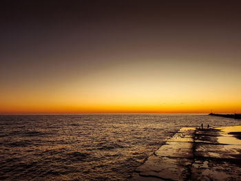 Scenic view of sea against clear sky during sunset