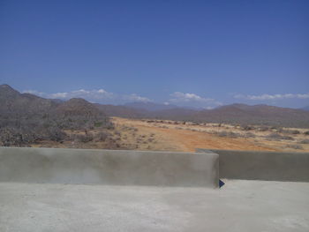 Scenic view of mountains against blue sky