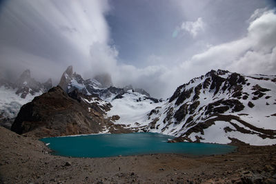 Scenic view of sea and mountains against sky